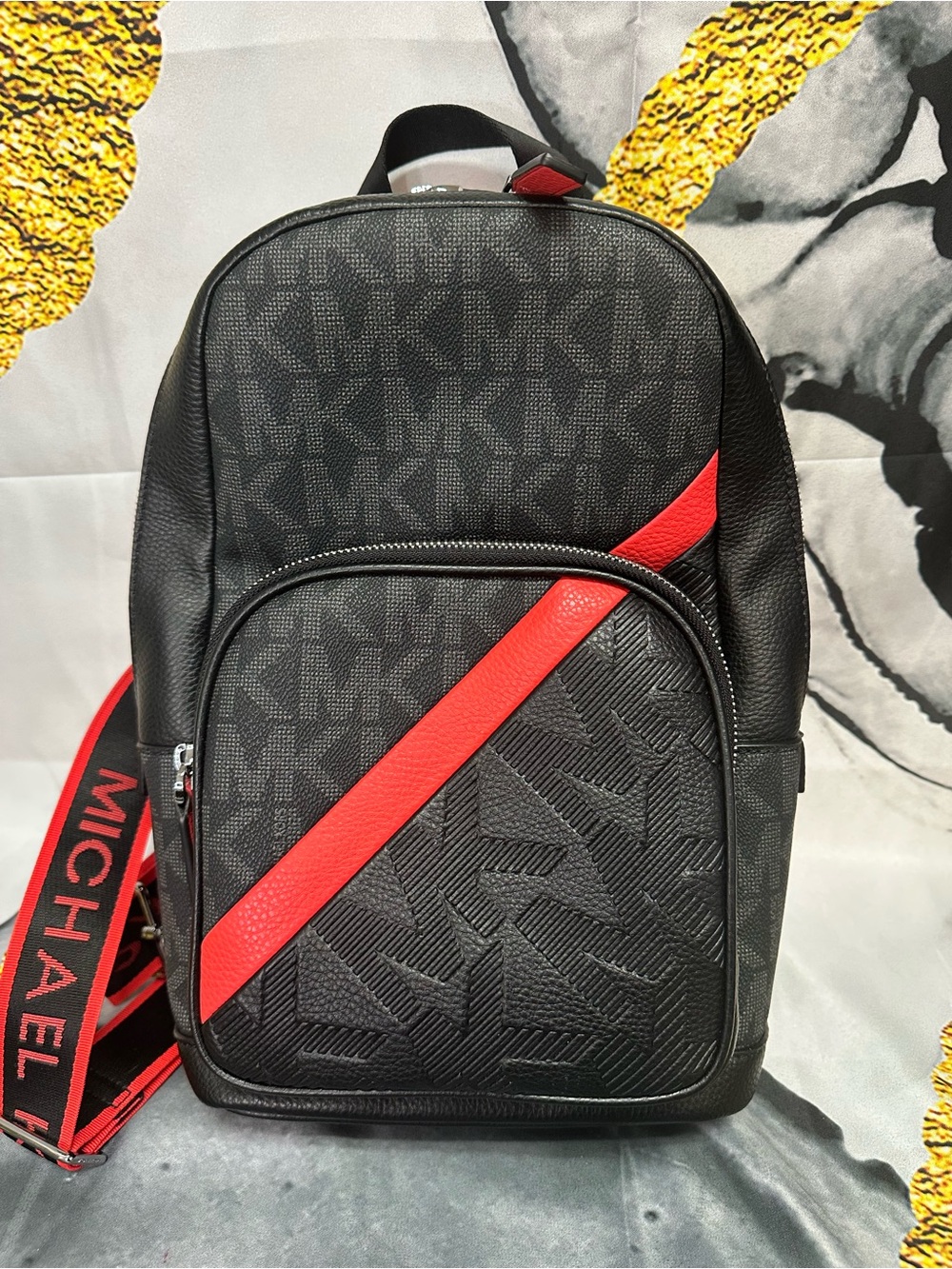 Michael Kors Black Sling Backpack with Red Diagonal Accent